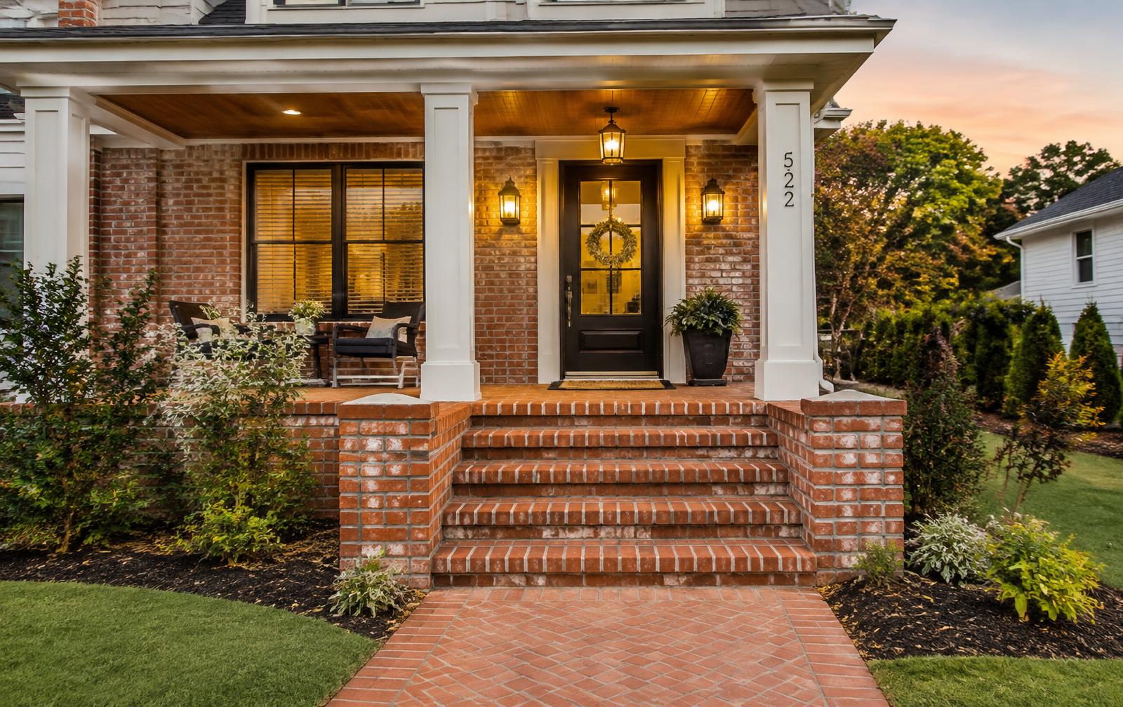 Illustrative renovated home exterior with custom brick steps, masonry and a covered porch